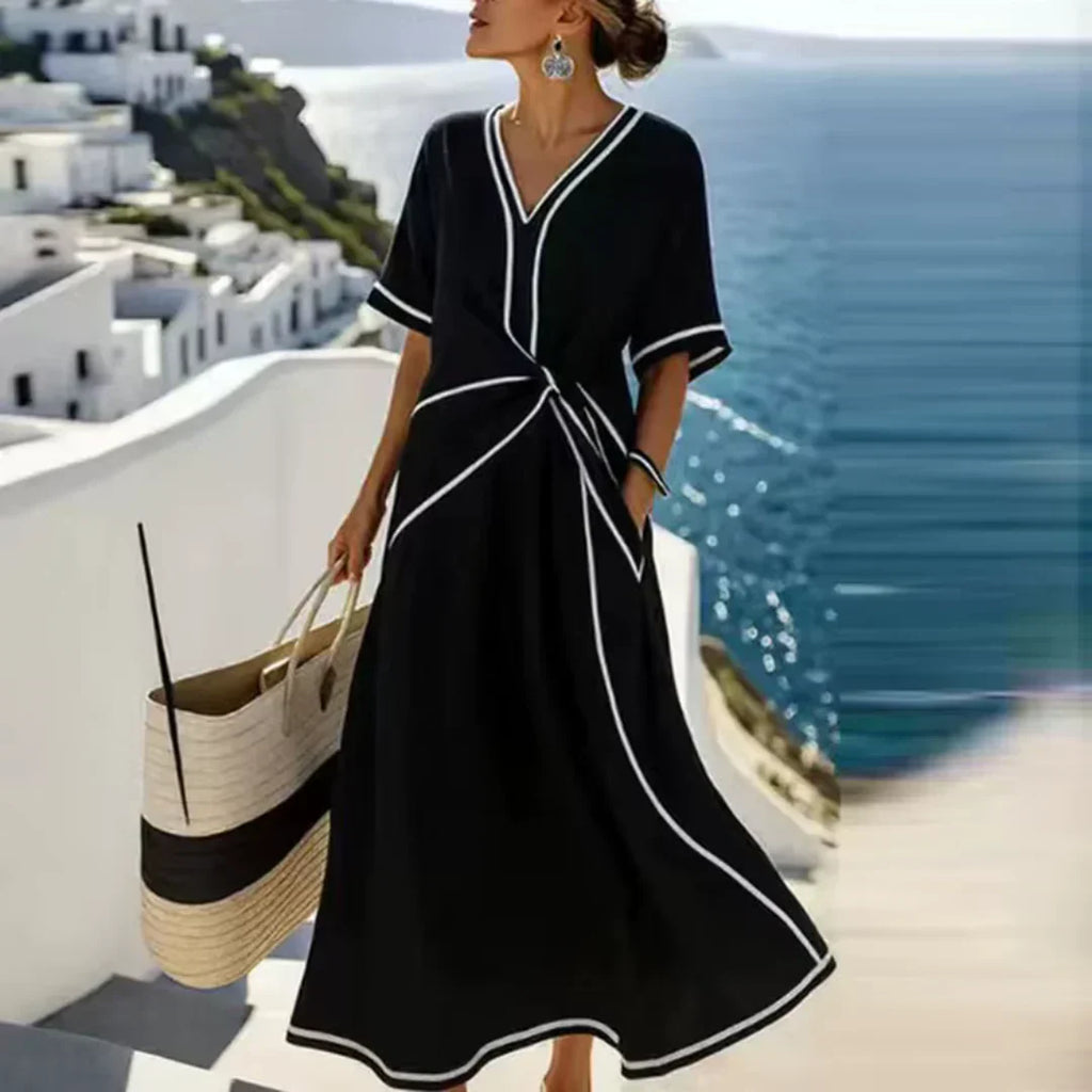 Softly woven dress with draped waist detail and a clean V-neckline.