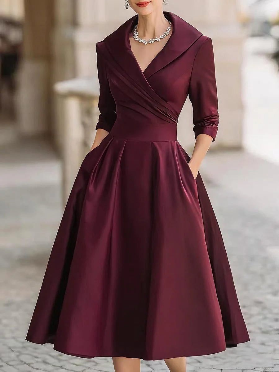 Draped-neckline dress with a fitted bodice, A-line skirt and hidden side pockets.