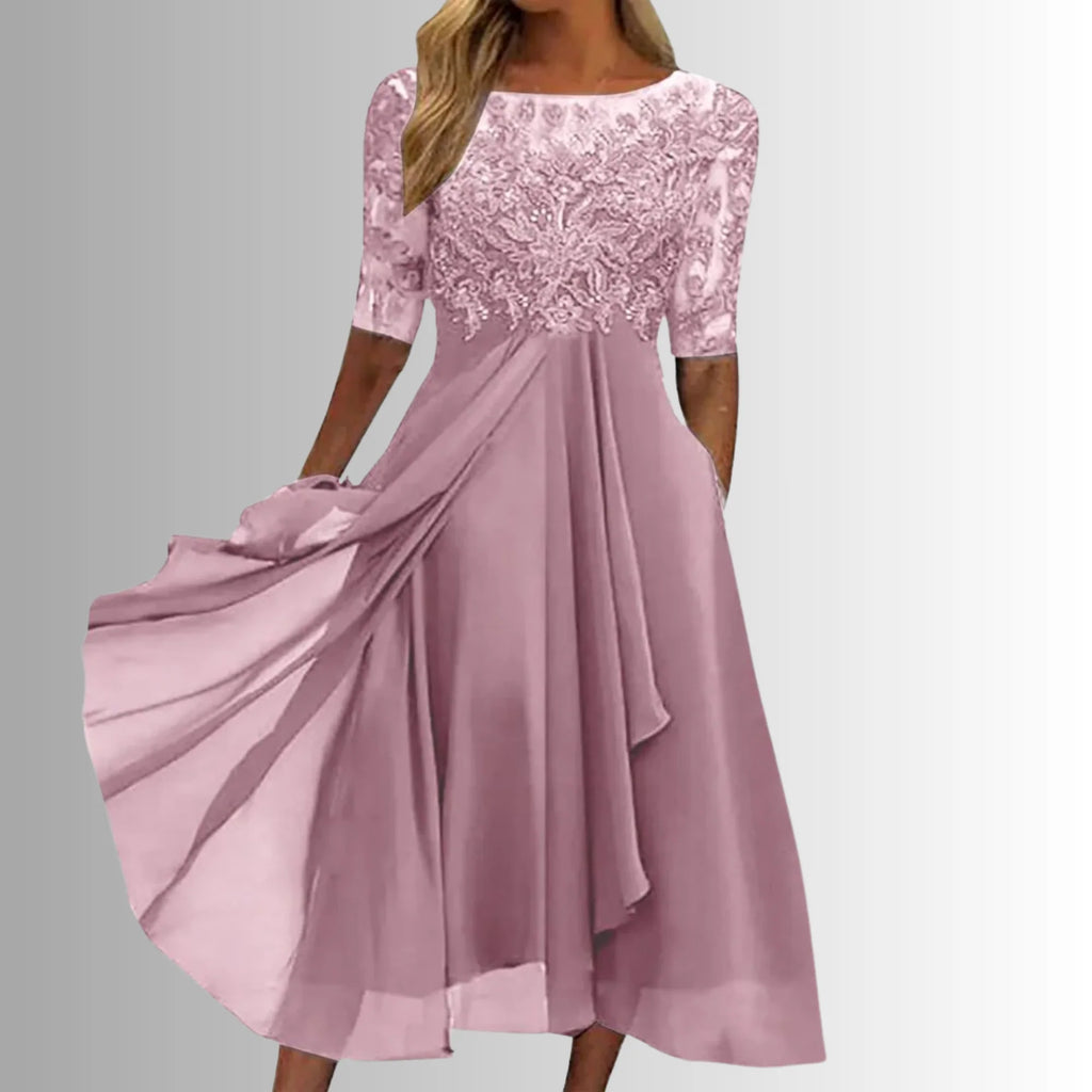 Occasion dress with a delicate lace bodice and a layered, feather-light skirt.