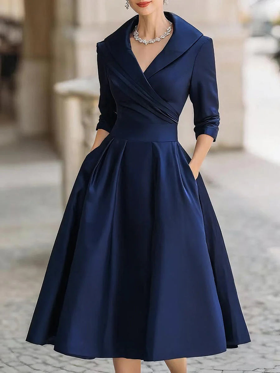Draped-neckline dress with a fitted bodice, A-line skirt and hidden side pockets.