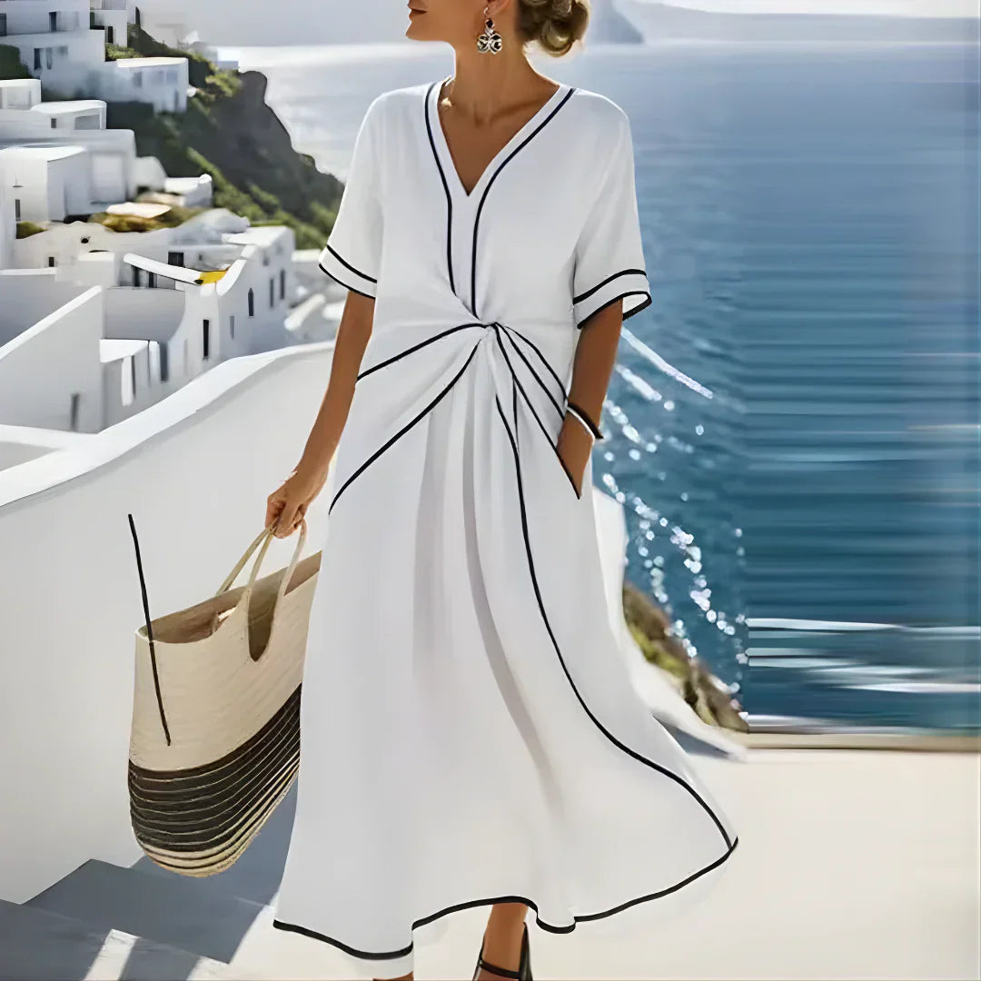 Softly woven dress with draped waist detail and a clean V-neckline.
