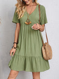 Elegant dress with soft layered detailing and a gently draped waist.