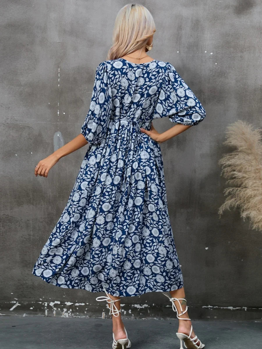 Printed V-neck dress with gathered lantern sleeves and a loose waist.