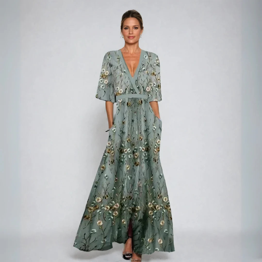 Elegant wrap-front maxi dress with a defined waist and a sweeping skirt.