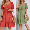 Elegant dress with soft layered detailing and a gently draped waist.