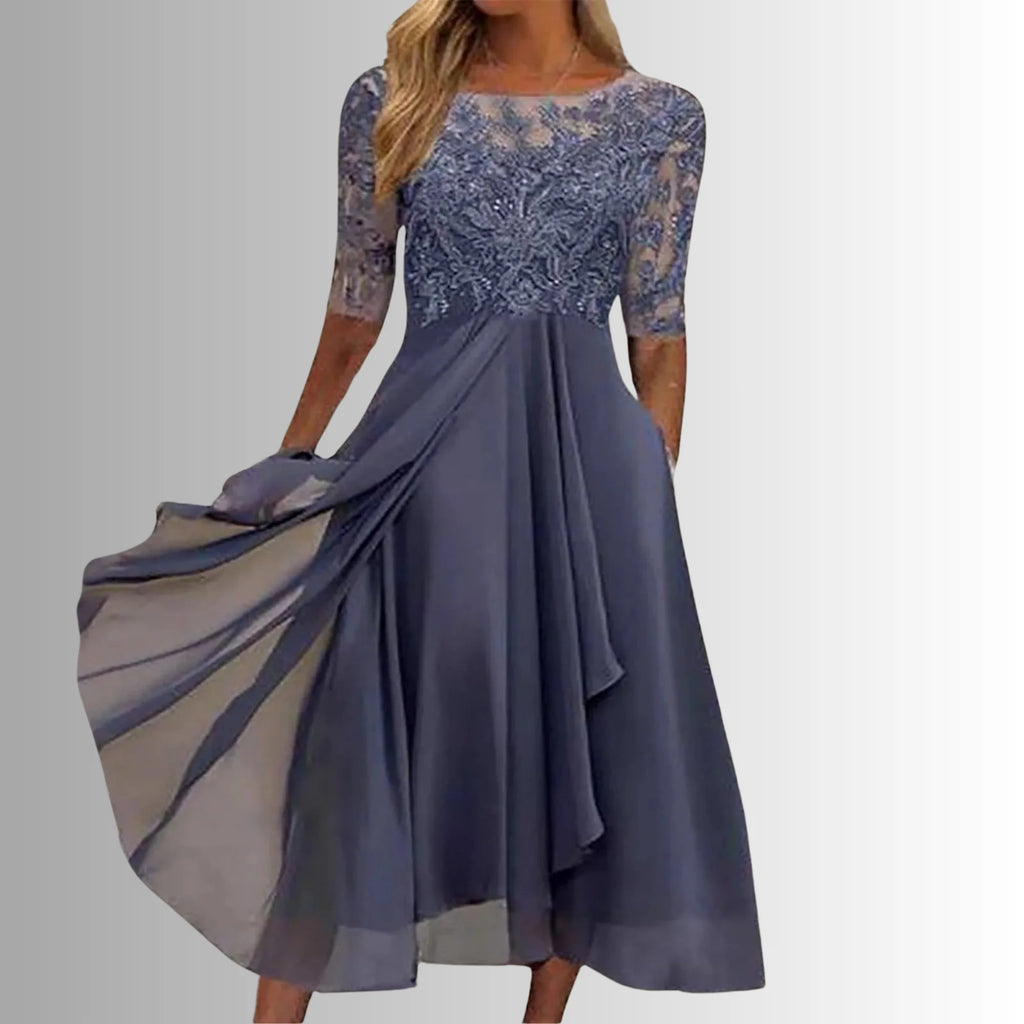 Occasion dress with a delicate lace bodice and a layered, feather-light skirt.