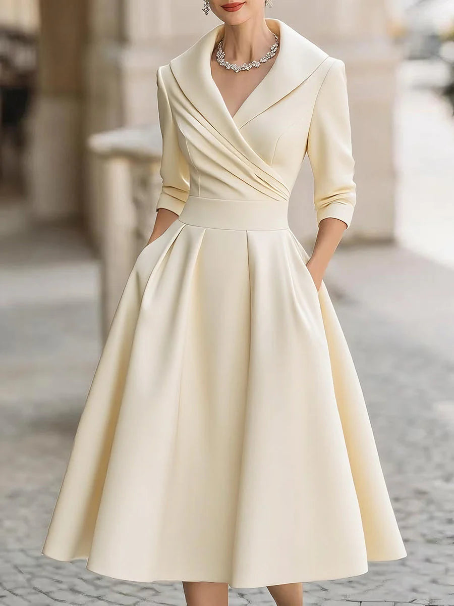 Draped-neckline dress with a fitted bodice, A-line skirt and hidden side pockets.