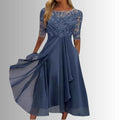 Occasion dress with a delicate lace bodice and a layered, feather-light skirt.