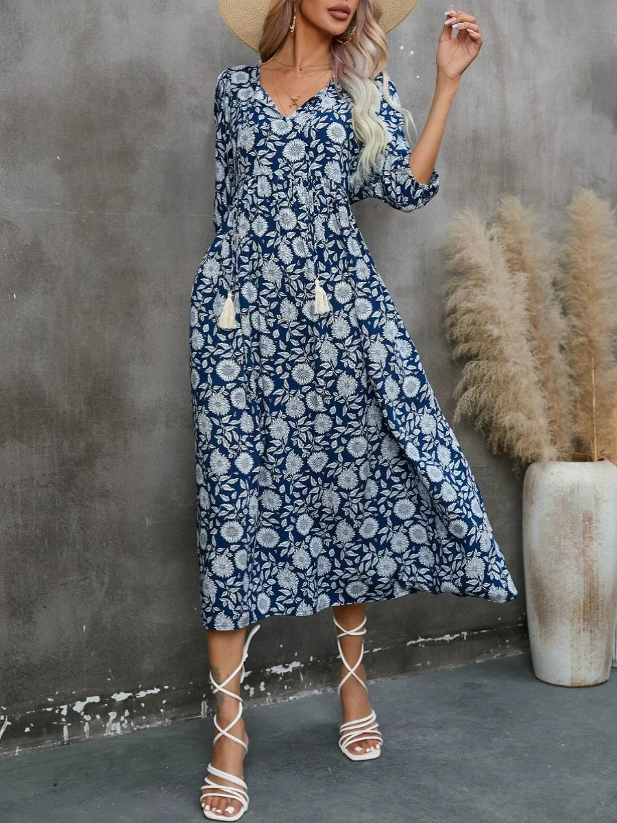 Printed V-neck dress with gathered lantern sleeves and a loose waist.