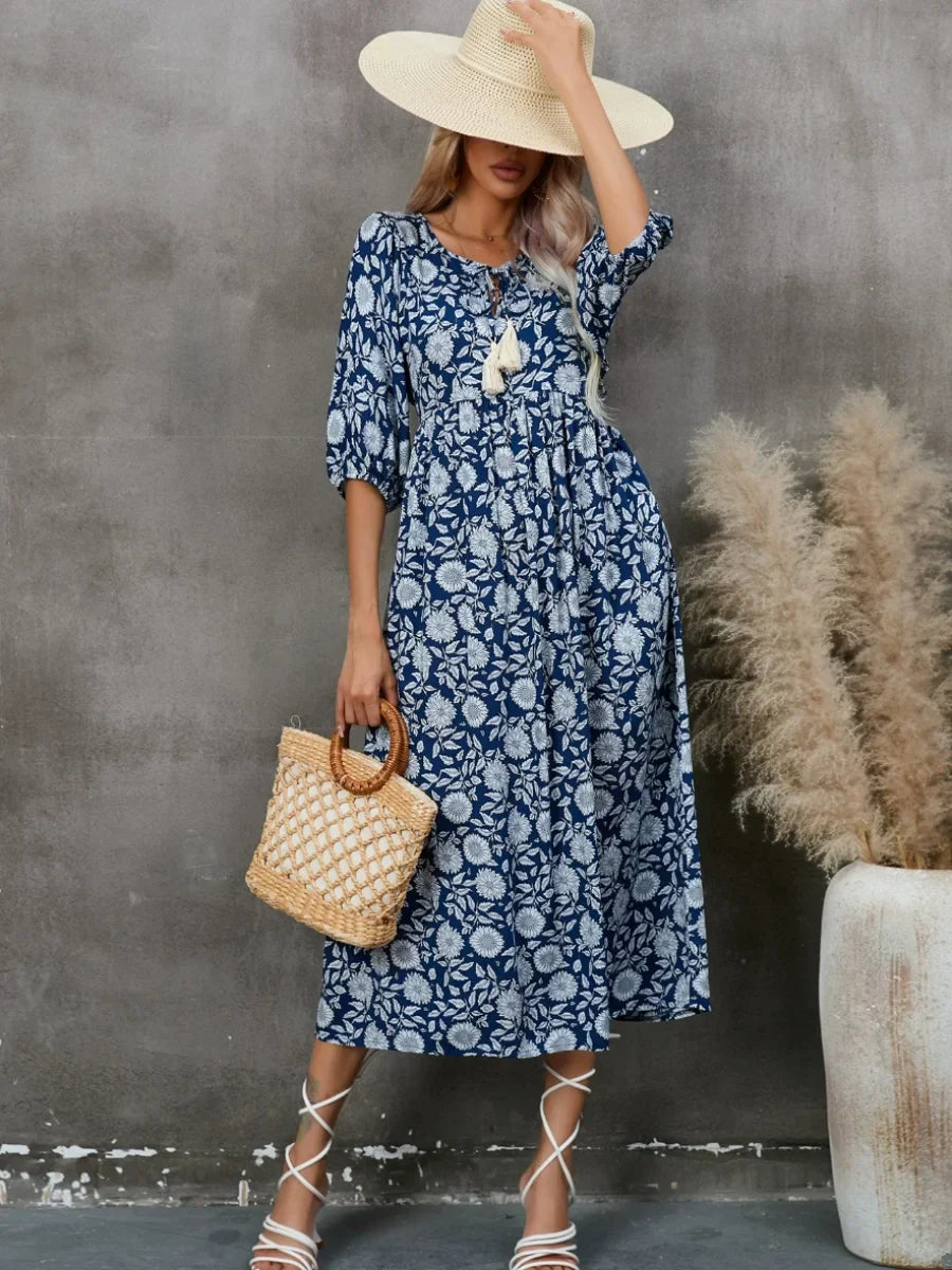Printed V-neck dress with gathered lantern sleeves and a loose waist.