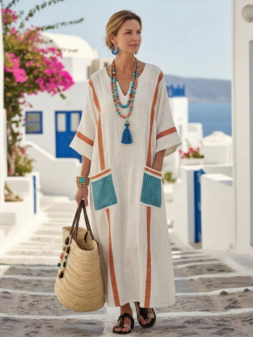 Relaxed dress with a soft V-neckline, half sleeves and front pockets.
